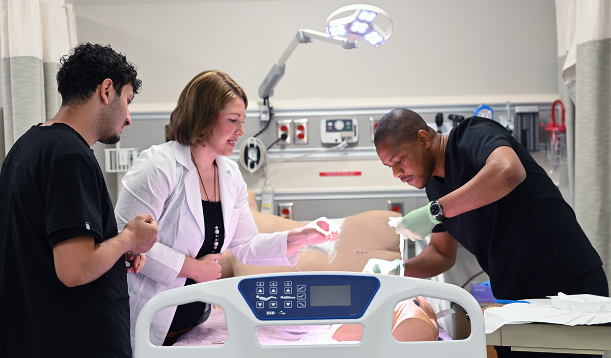 Practical nursing students receiving hands-on training in the simulation lab