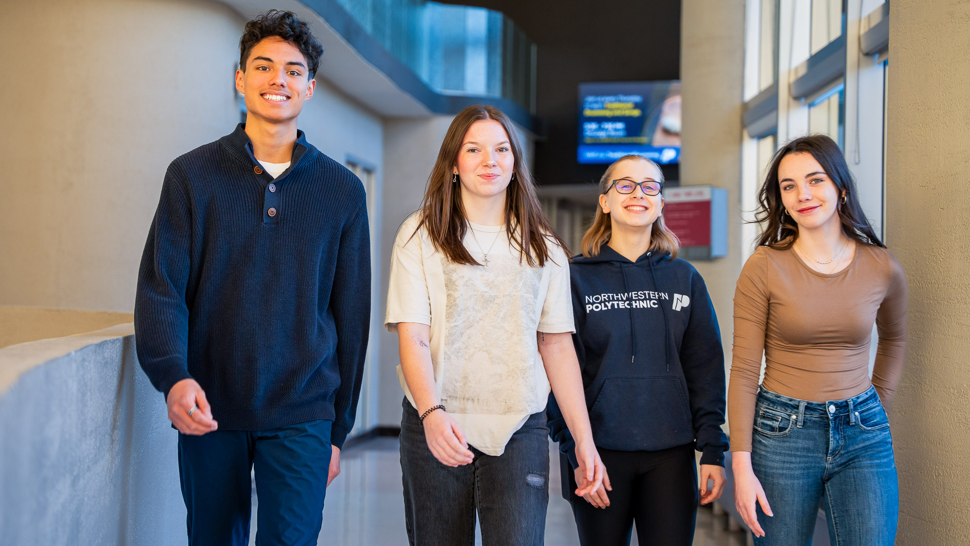 Happy NWP students walking down a hallway on the Grande Prairie campus