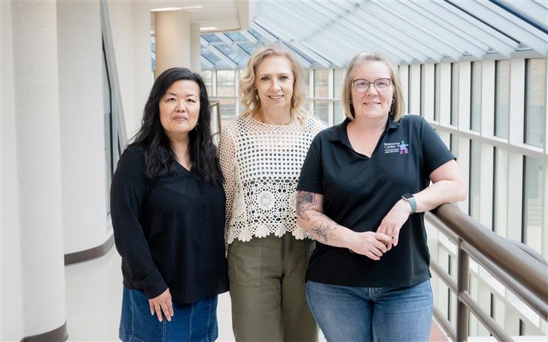 Three women who are working on the project standing in the NWP hallway
