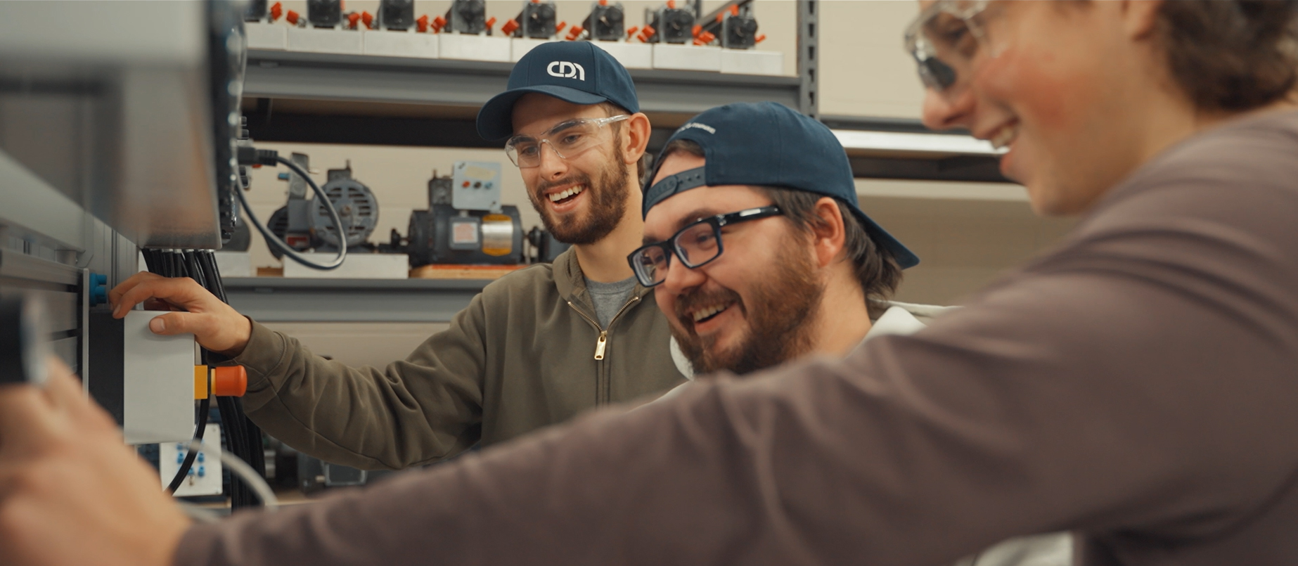 Group of happy electrical students collaborating on a project in the CDN Electrical Education Centre lab