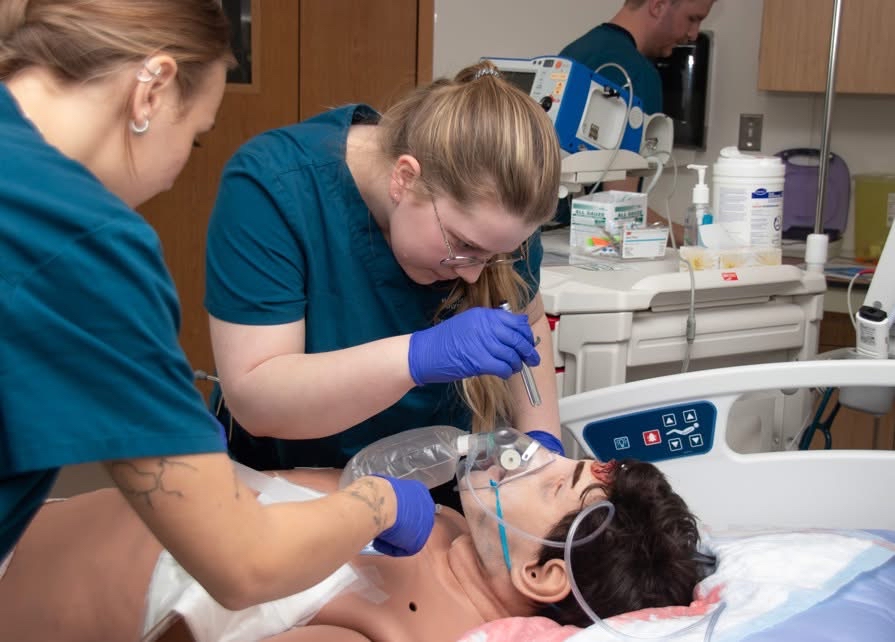 Students practicing on simulation mannequin