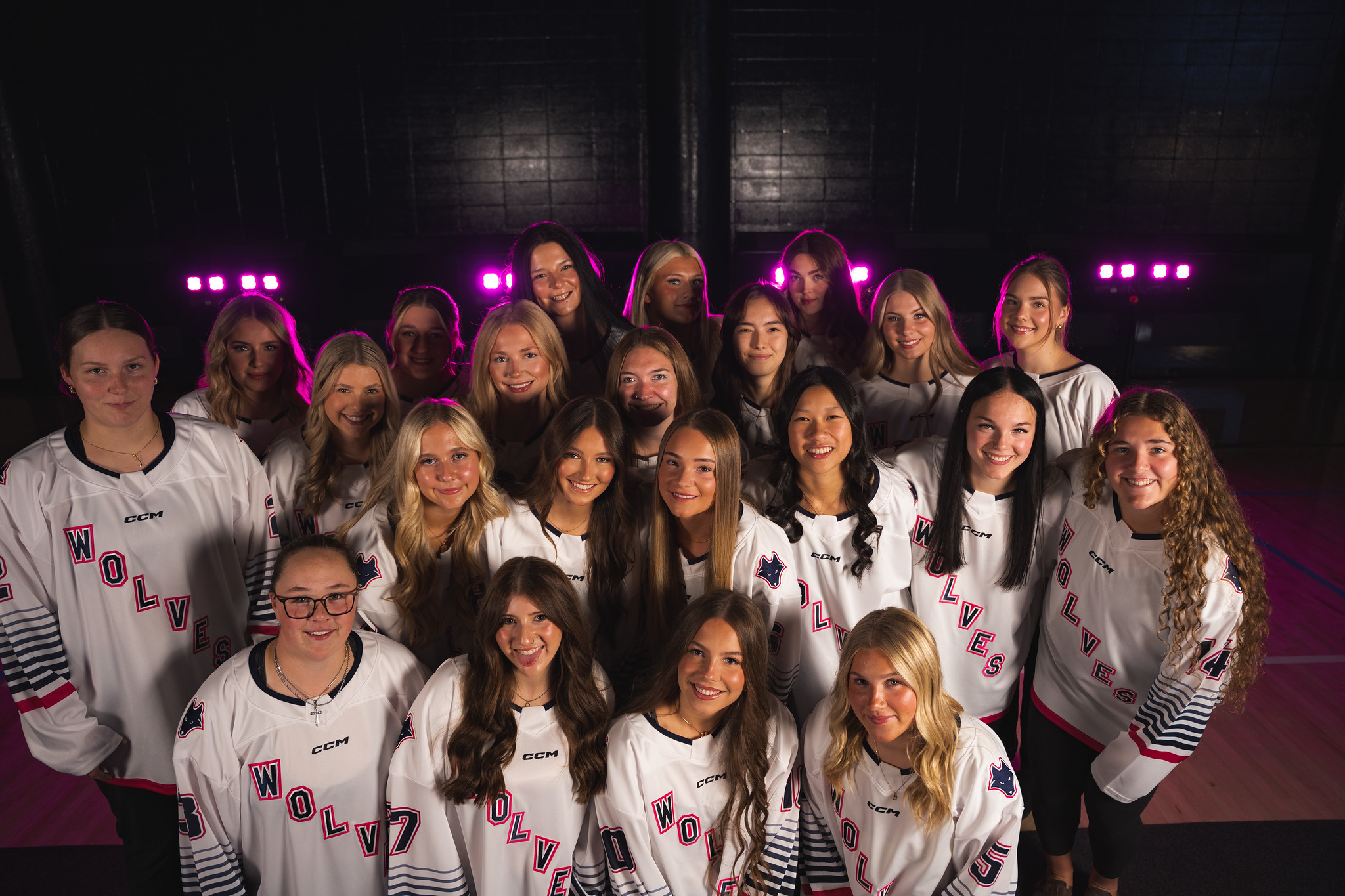 The Wolves Women's Hockey team takes a selfie while wearing their jerseys.