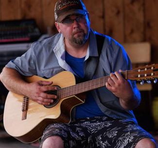 Justin Beaucage playing guitar