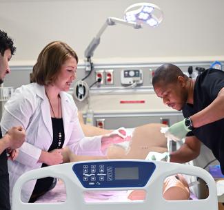 Practical nursing students receiving hands-on training in the simulation lab