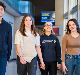 Happy NWP students walking down a hallway on the Grande Prairie campus
