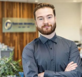 Aedon Janes, NWP alumni in an office setting
