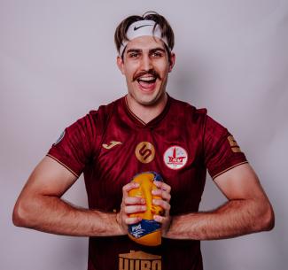 Wolves Volleyball Alumni, Tom Wheeler squeezing a volleyball flat