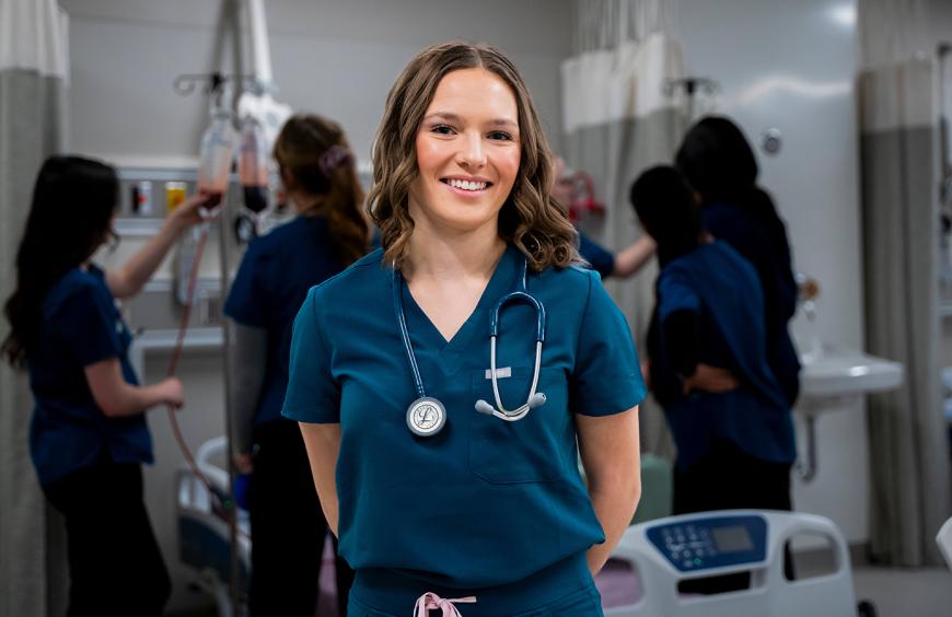 Student nurse posing in the simulation lab