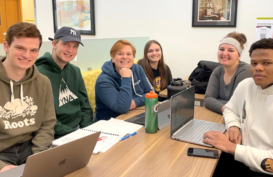 Teresa Evans, Nursing instructor around a table with students