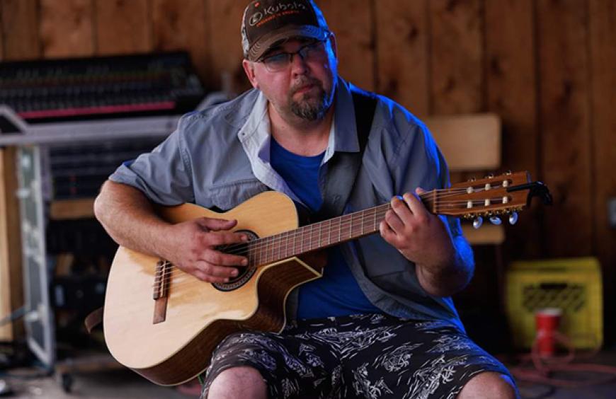 Justin Beaucage playing guitar