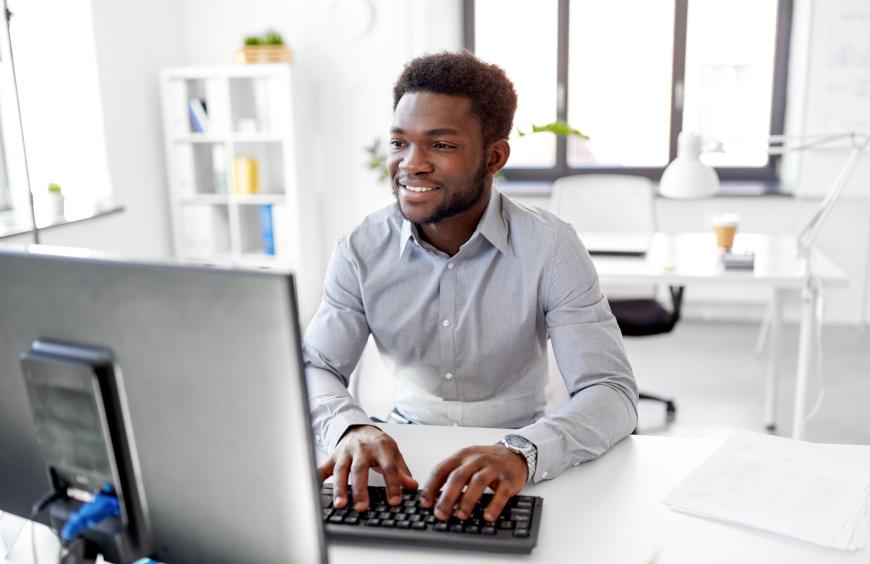 Man working at his desk typing on a keyboard