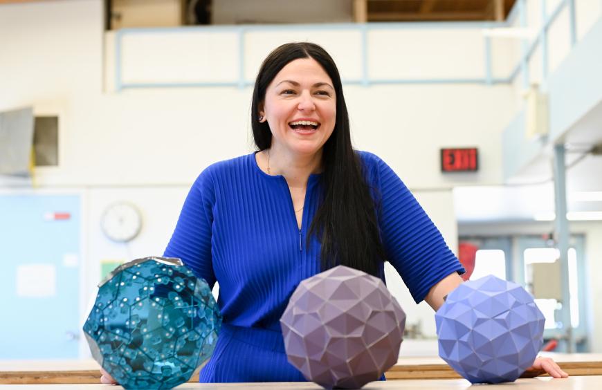 Fine Arts instructor, Laura Marotta shares a laugh while displaying an art installation