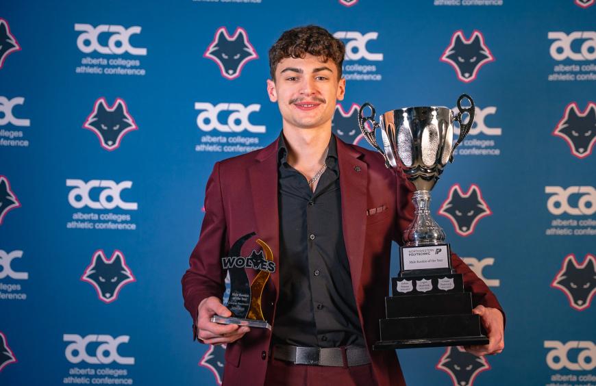 Cooper Paulovich holding his rookie of the year trophies at the Festival of Gold Ceremony