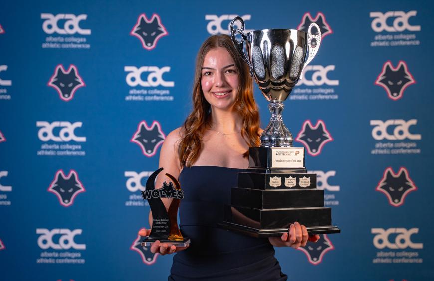 Emma Van Dijk holding her rookie of the year trophies at the Festival of Gold Ceremony
