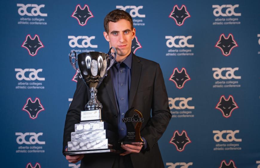 Evan Doerksen posing with his Athlete of the Year trophy at the Wolves Festival of Gold Awards Ceremony