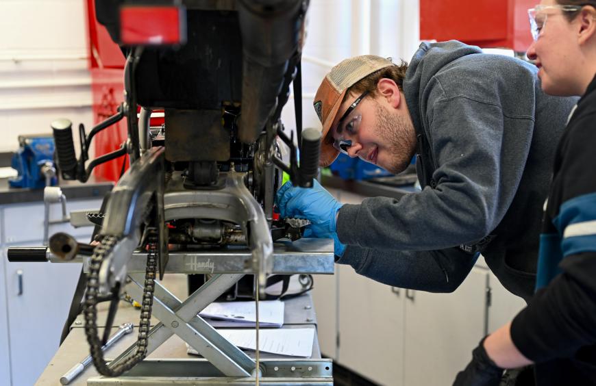 Apprenticeship students working on a motorcycle in the workshop at Fairview 