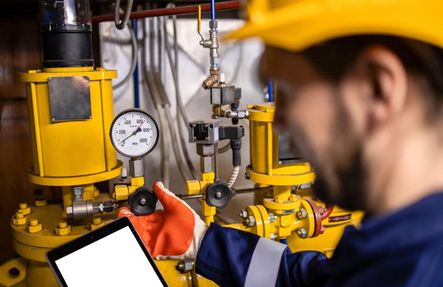 Instrumentation tech reading and adjusting a gauge