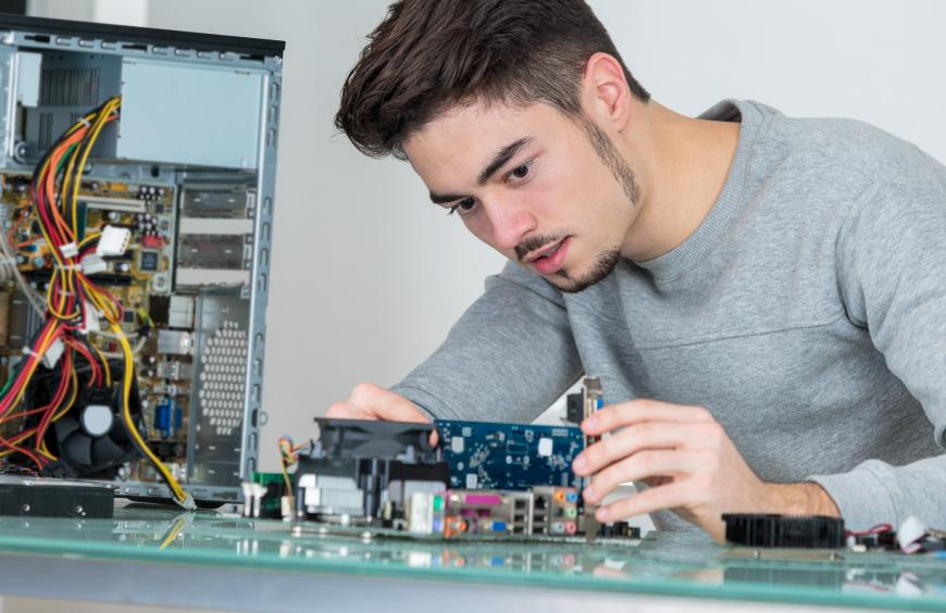 a young IT professional fixing computer hardware