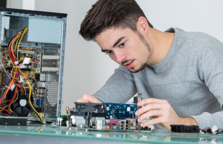 a young IT professional fixing computer hardware