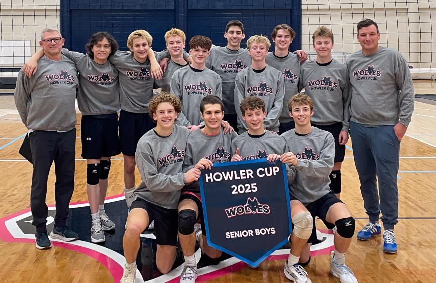 The Charles Spencer high school senior boys volleyball squad posing in the NWP gym holding up their championship banner