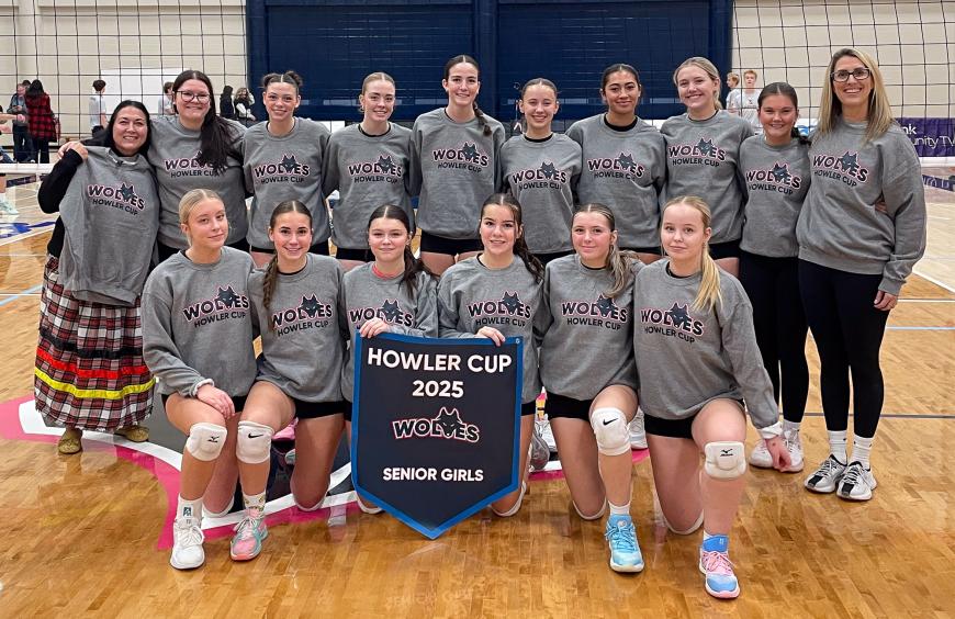 The Charles Spencer high school senior girls volleyball squad posing in the NWP gym holding up their championship banner