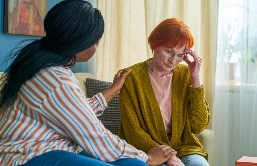 Social worker displaying compassion to an elderly client facing a challenge