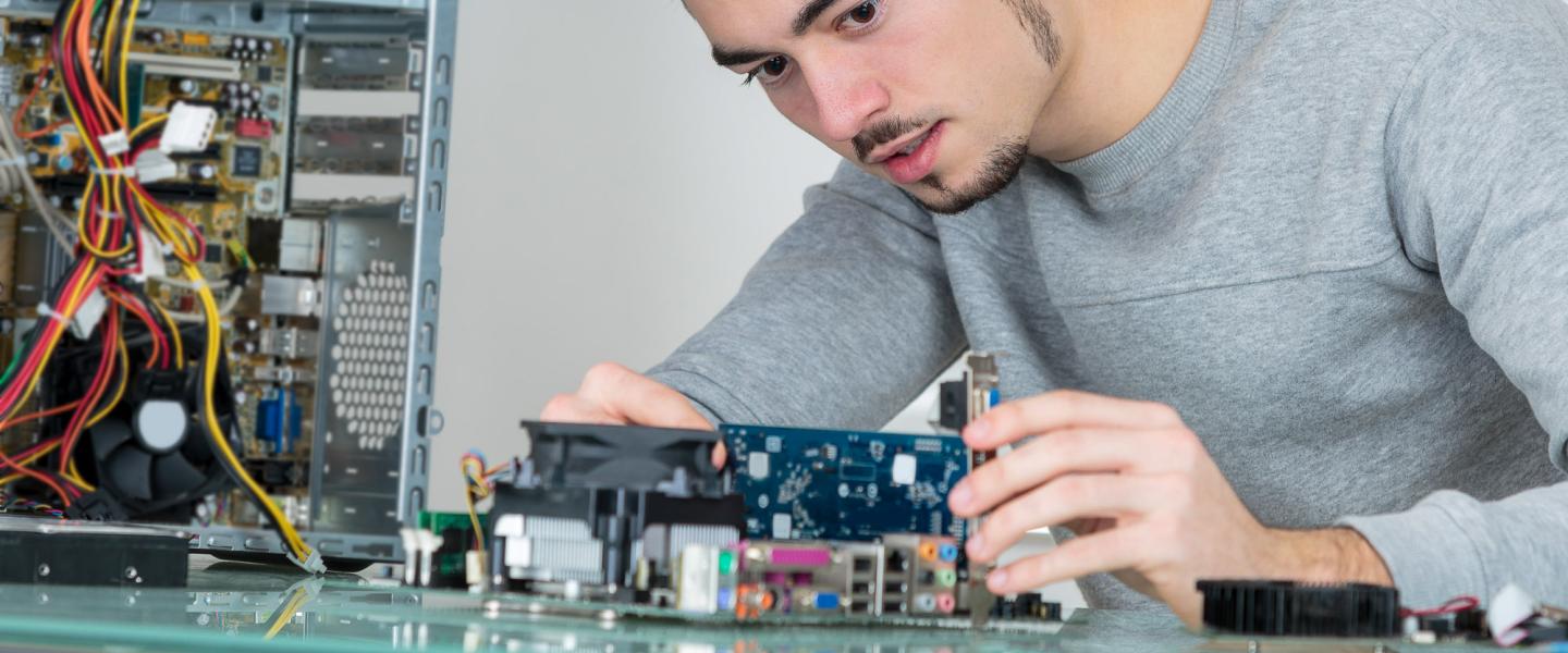 a young IT professional fixing computer hardware