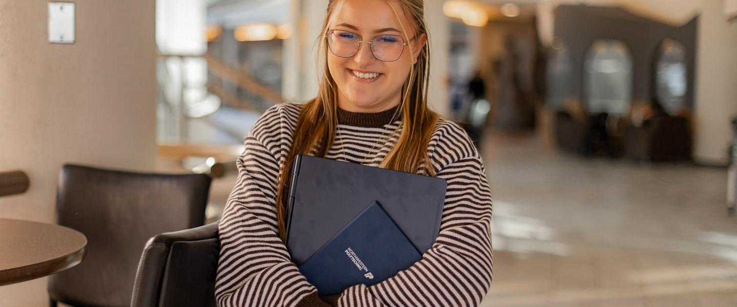 Two happy students studying in a classroom