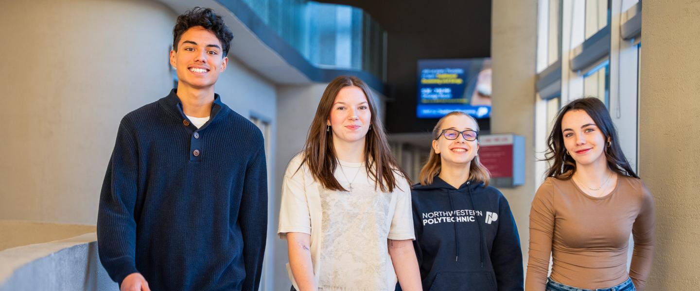 Happy NWP students walking down a hallway on the Grande Prairie campus