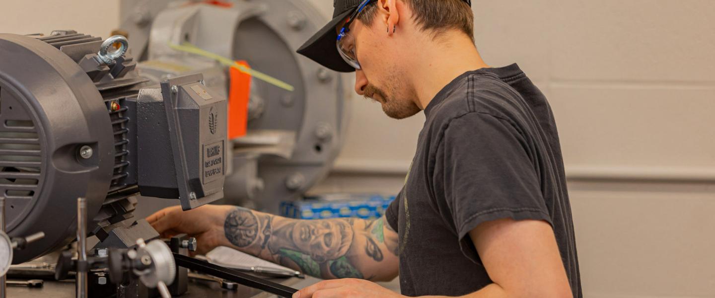 A millwright student using machinery in the trades lab
