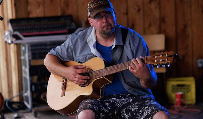 Justin Beaucage playing guitar