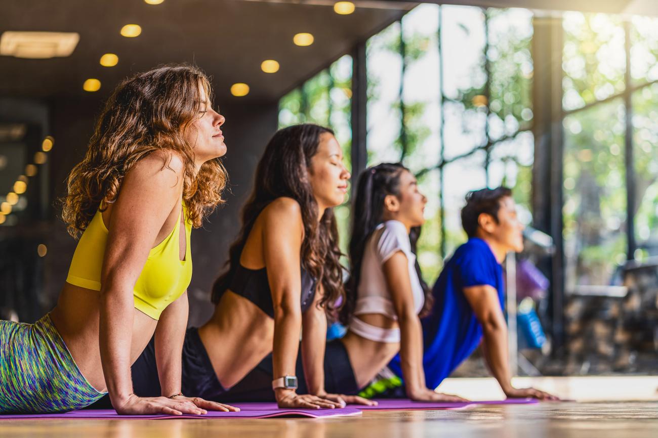 Yoga class participants holding a pose