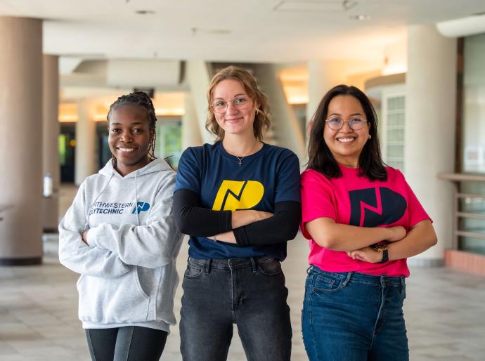 three students posing on the DJC concourse