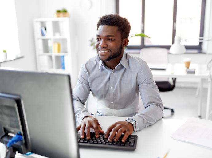 Man working at his desk typing on a keyboard