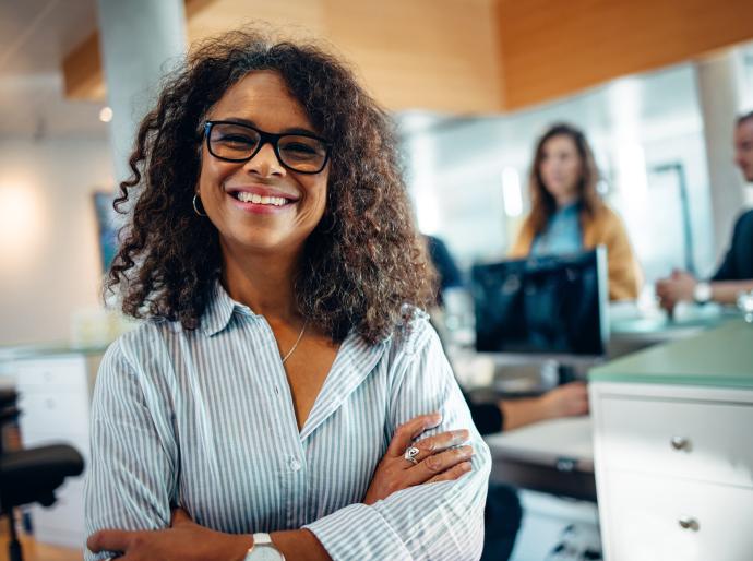 Happy office manager in busy workplace