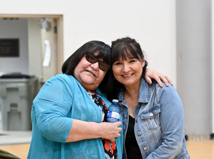 Elder in Residence Theresa Gladue and NWP Financial Aid Advisor Bernie Matlock share an embrace at the Circle of Indigenous Students year end celebration