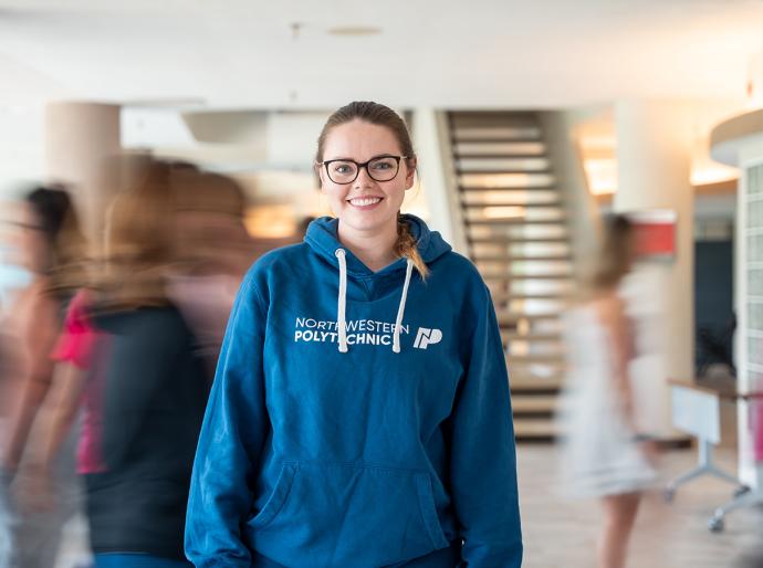 Proud NWP employee posing in a branded blue hoodie