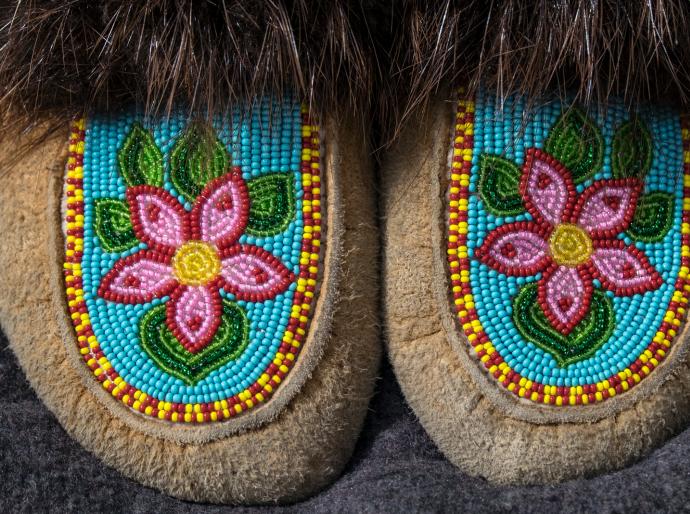 Close up of the colourful beadwork on a pair of moccasins.