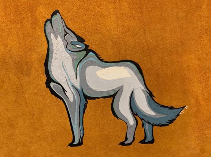Closeup of a howling wolf painting on the rawhide of an traditional Indigenous hand drum