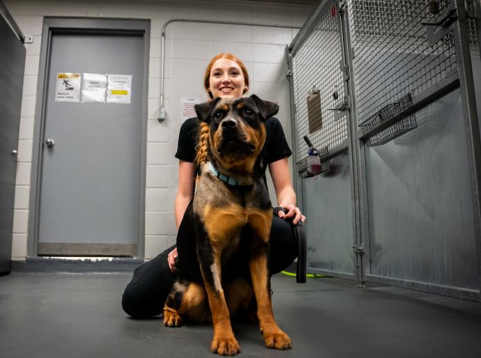Veterinary technology student posing with a cute puppy