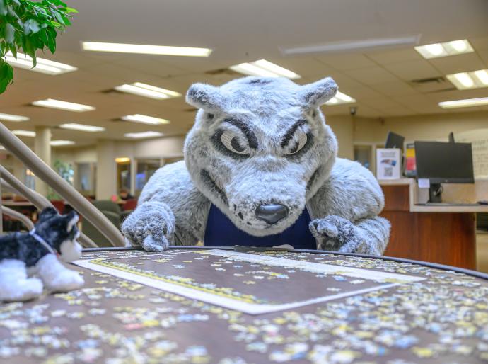 Farley the mascot putting puzzle pieces together