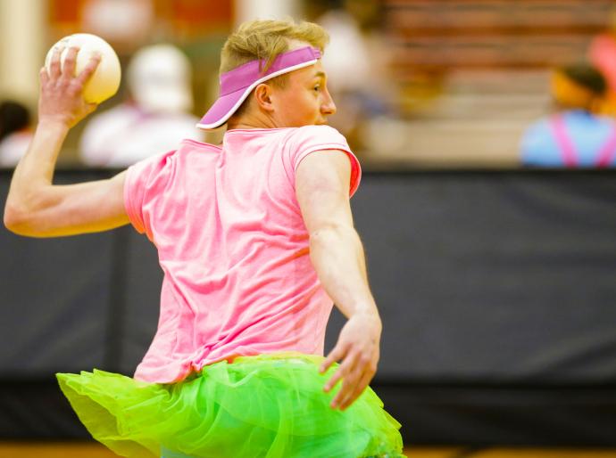 Student in brightly coloured clothing about to throw a dodgeball
