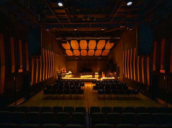 The stage of the recital hall filled with candles set up for the valentines serenade performance