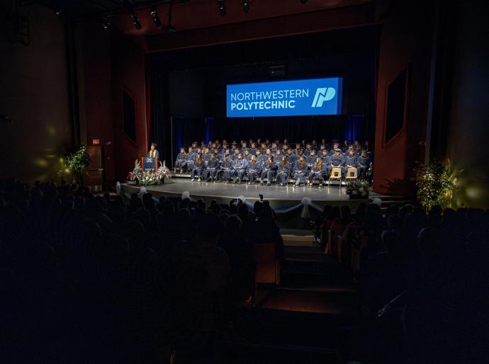 Birds eye view of the Fred Speckeen theatre full of graduates and their friends and family at convocation 2025