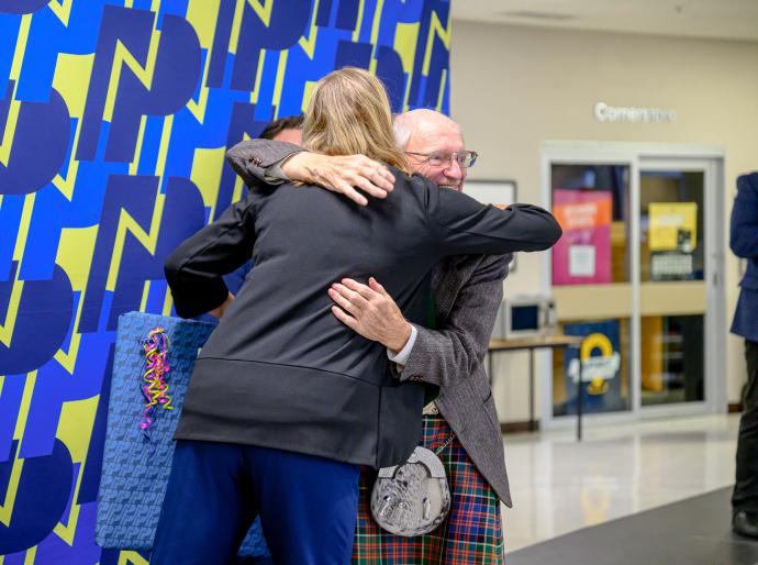 Long service award recipient sharing an embrace with the NWP President and CEO