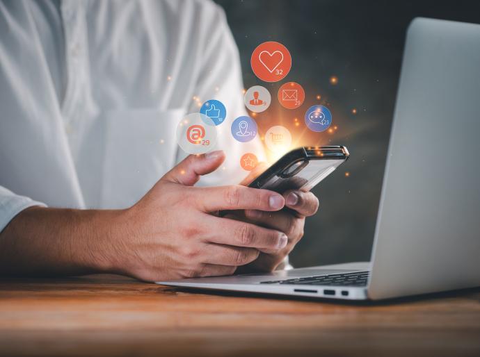 Close up of someone holding a phone and using social media