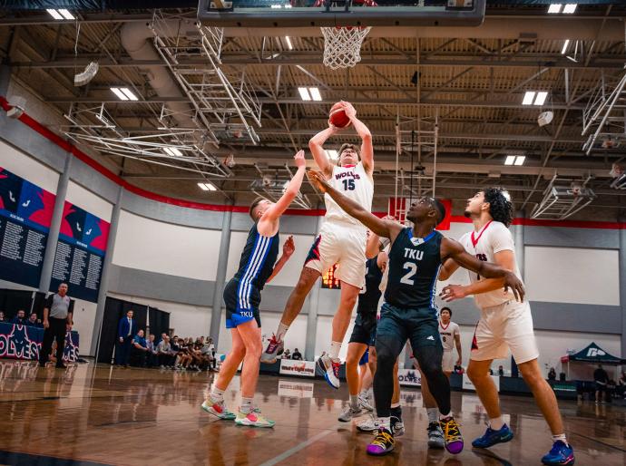Men's basketball players battling it out at the hoop