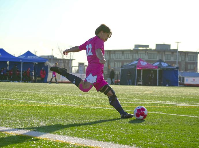 Men's soccer player taking a free kick for the Wolves