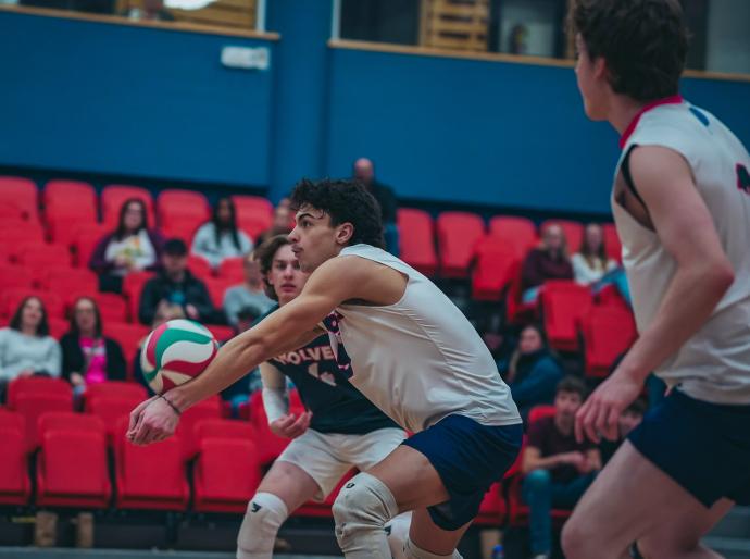 Mens wolves volleyball player receiving the ball