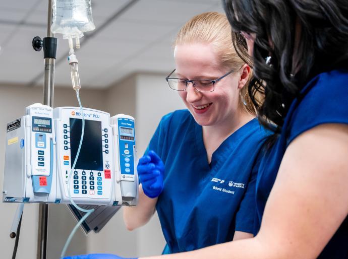 Nursing student administering an IV in the simulation lab